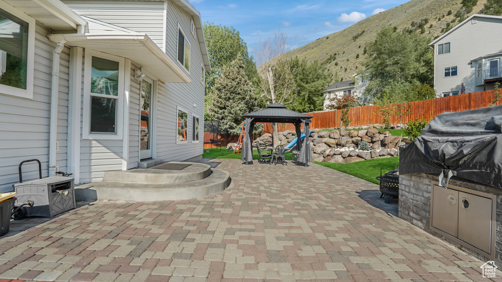 View of patio with a gazebo and a mountain view