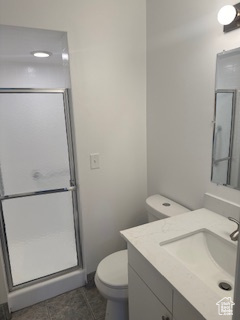 Bathroom with vanity, a stall shower, and tile patterned floors
