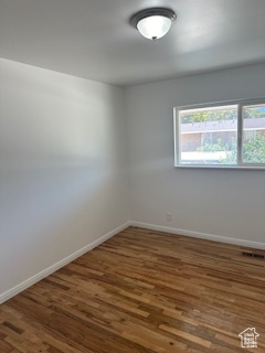 Empty room with wood finished floors and baseboards