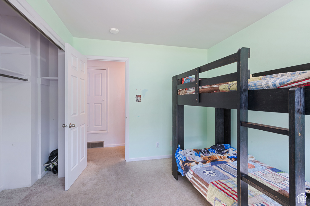 Carpeted bedroom featuring baseboards