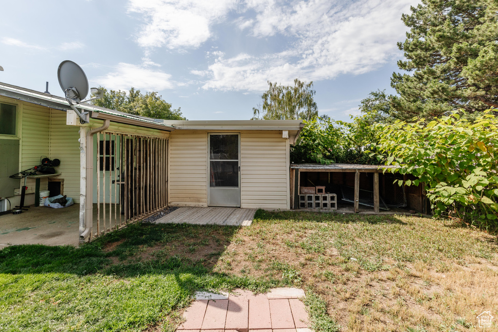 Back of property featuring a yard