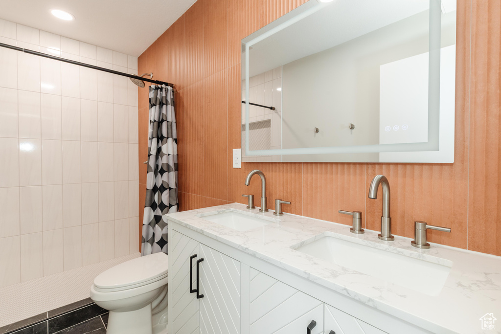 Bathroom with double vanity and a tile shower