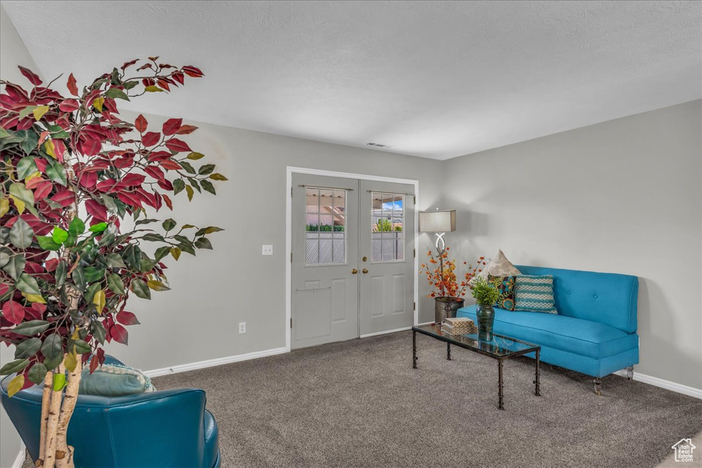 Living room featuring carpet floors and french doors
