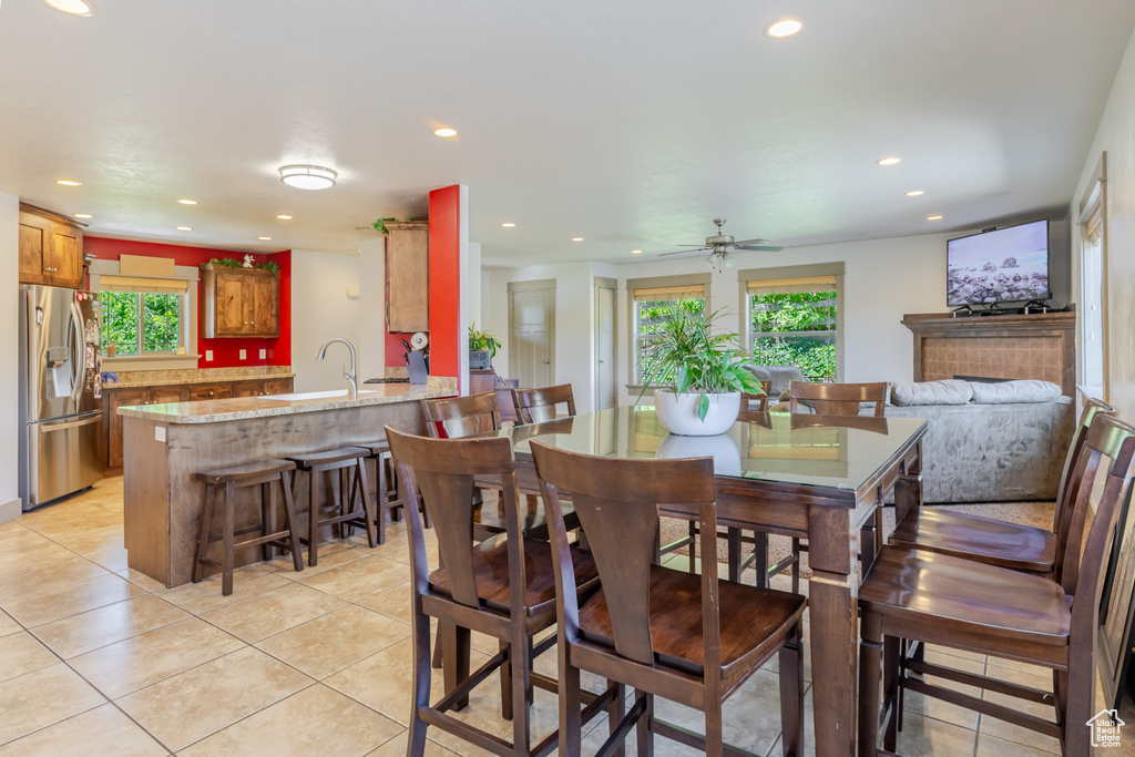 Dining room with plenty of natural light, recessed lighting, light tile patterned floors, and ceiling fan