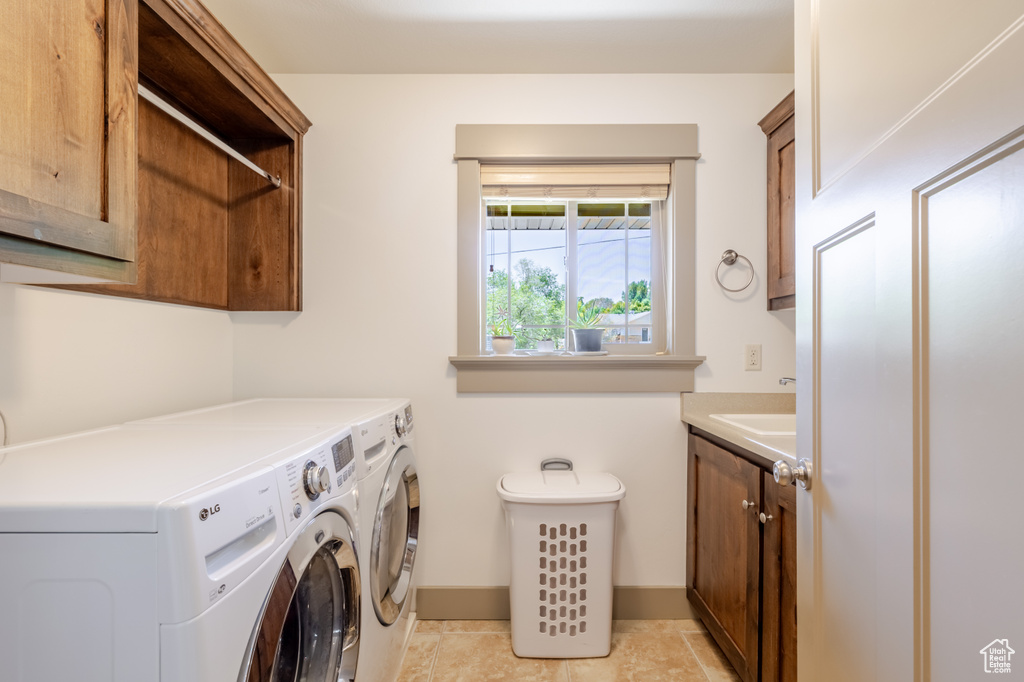 Laundry area with independent washer and dryer and cabinet space