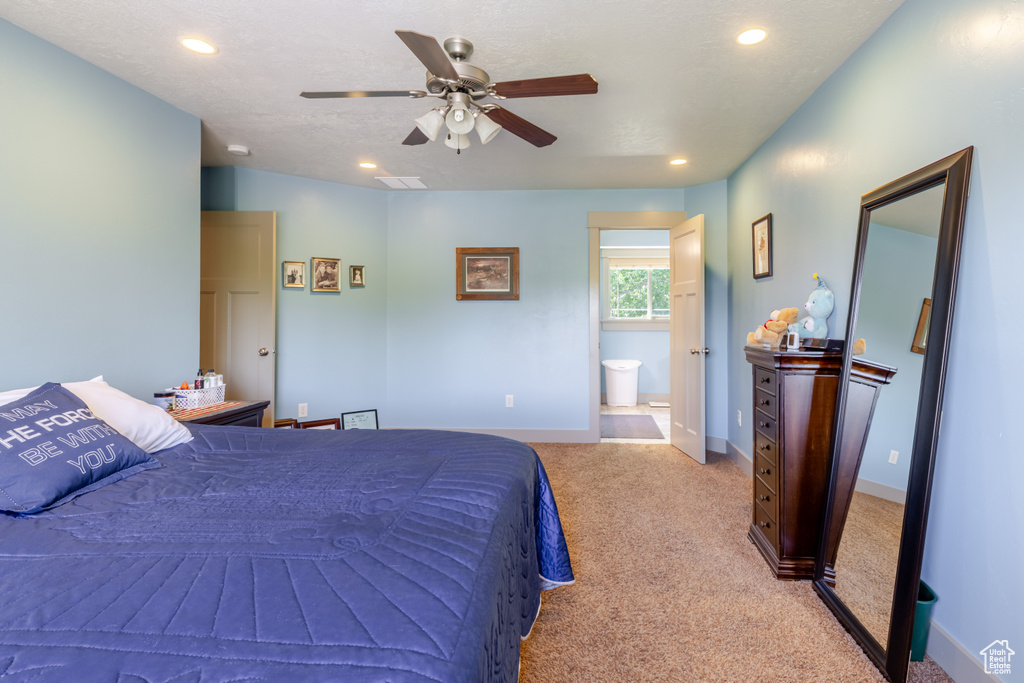 Bedroom with light carpet, recessed lighting, a ceiling fan, and ensuite bathroom