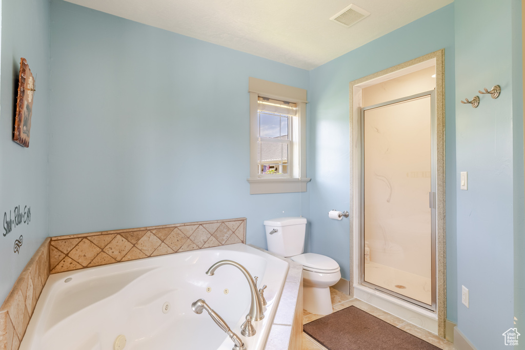 Full bath featuring a tub with jets and a stall shower
