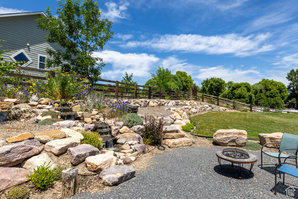 View of yard featuring an outdoor fire pit and a patio