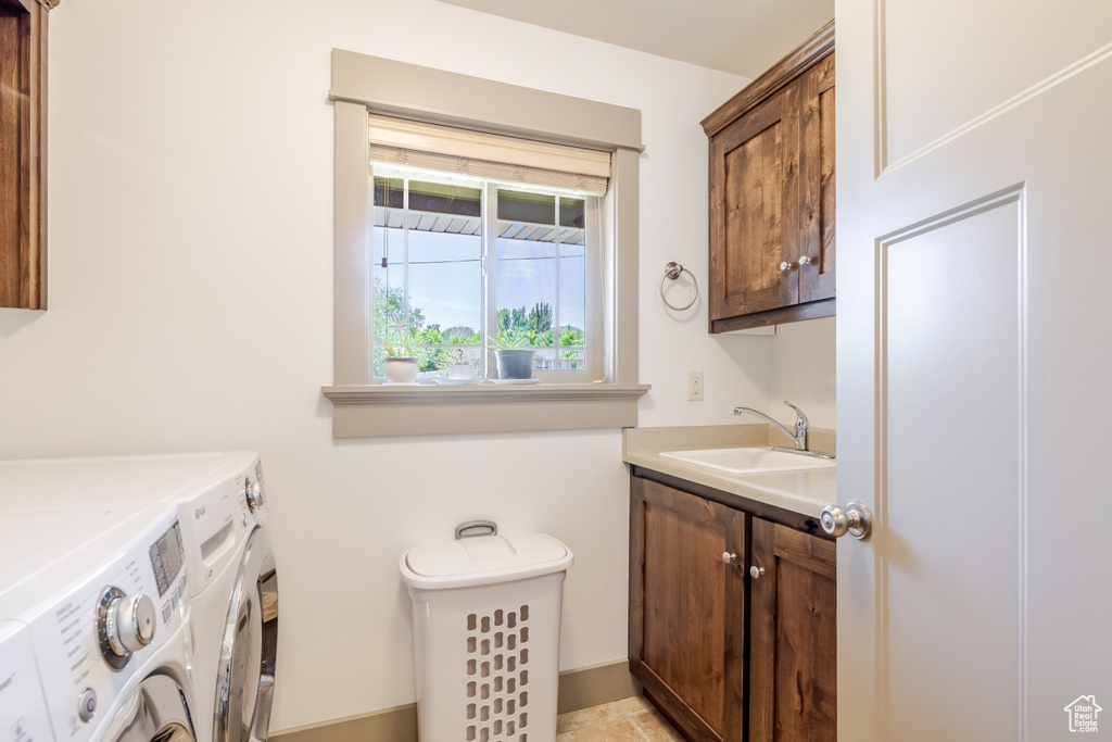 Laundry room featuring washer and clothes dryer and cabinet space