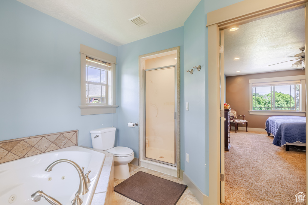 Ensuite bathroom with a jetted tub, a stall shower, and ceiling fan