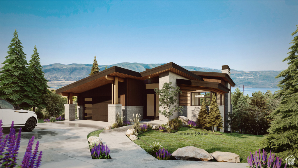 Modern home with a mountain view, stone siding, a chimney, a garage, and driveway