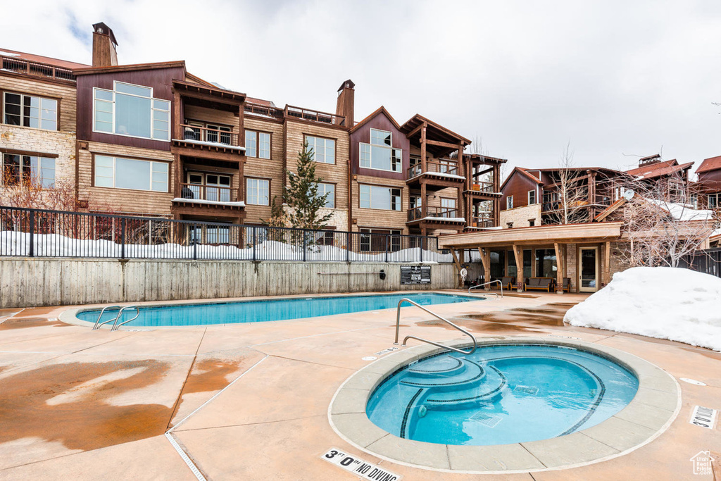 Community pool with a community hot tub and a patio area