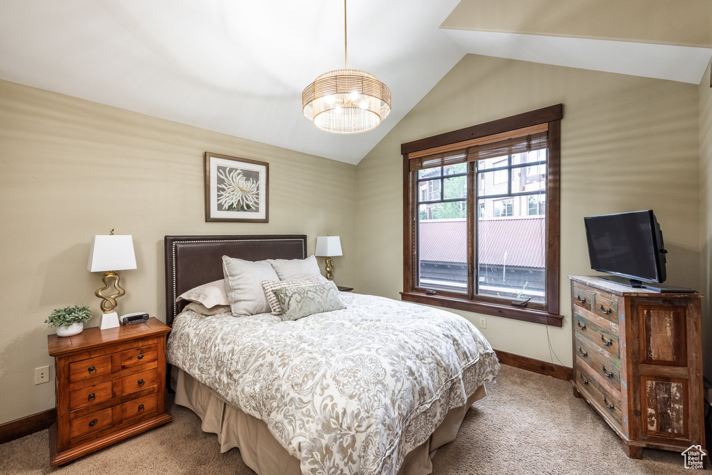 Bedroom with lofted ceiling and carpet flooring