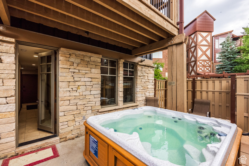 View of patio featuring a hot tub
