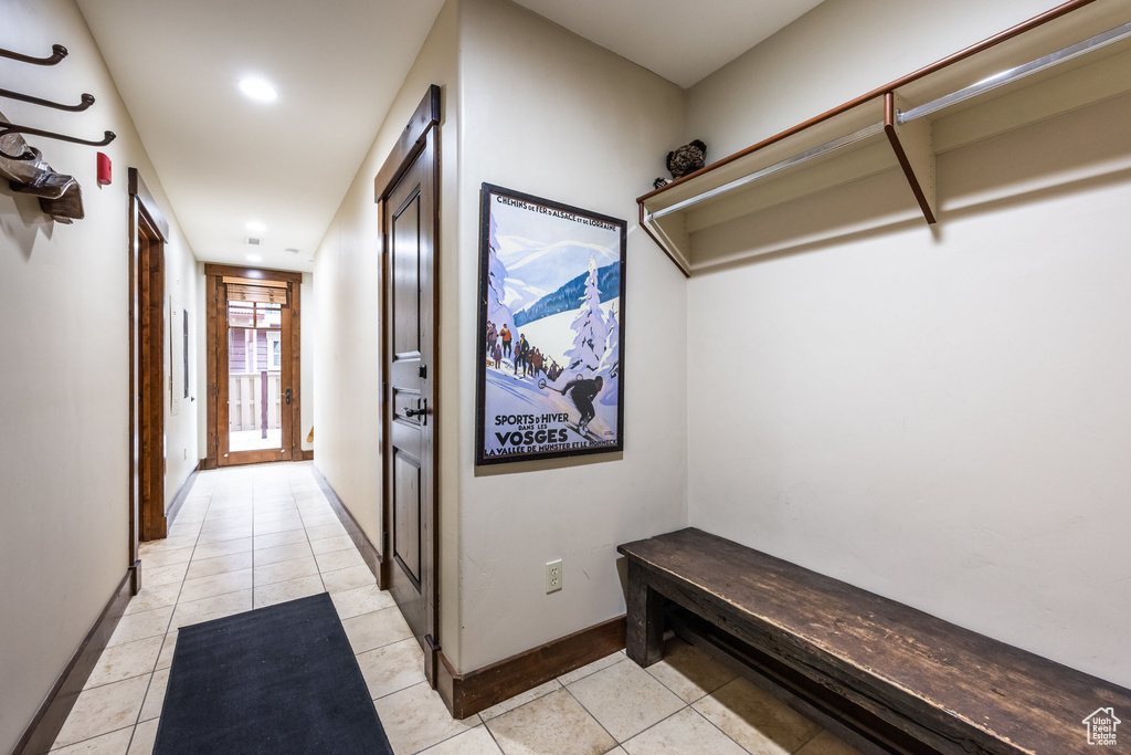 Hallway featuring light tile patterned floors and recessed lighting