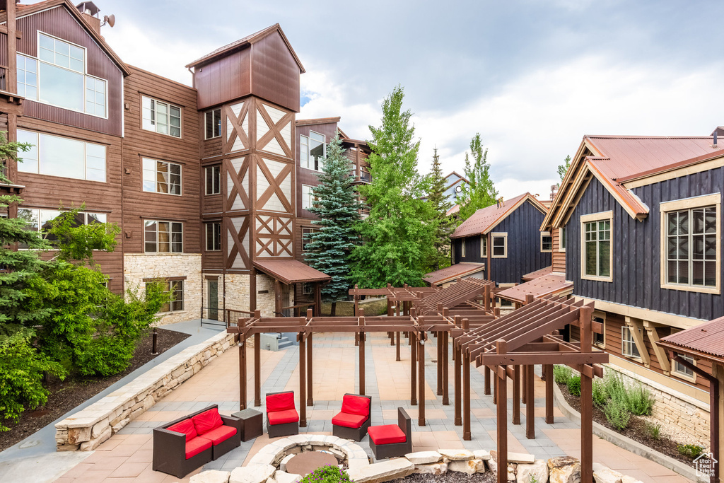 Surrounding community featuring an outdoor living space with a fire pit and a patio