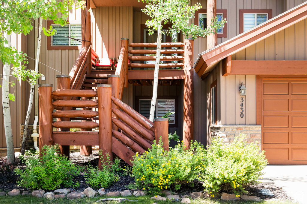 Entrance to property featuring stone siding