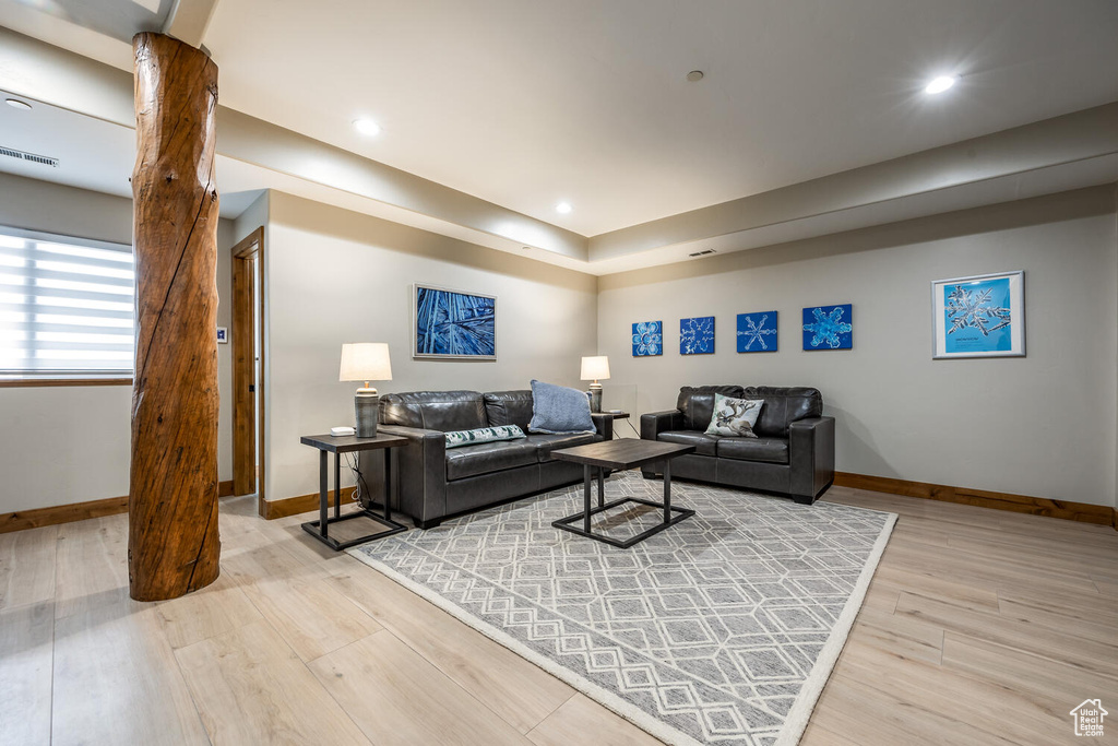 Living room featuring light wood-style flooring and recessed lighting