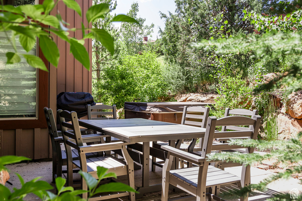 View of patio with outdoor dining area and grilling area