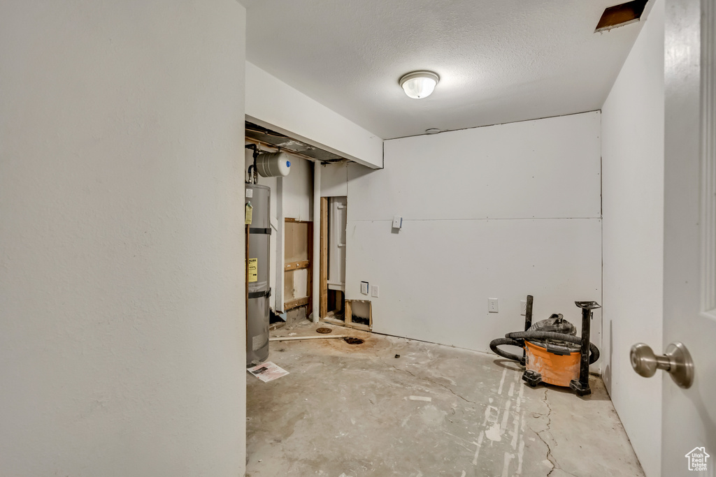 Finished basement featuring strapped water heater