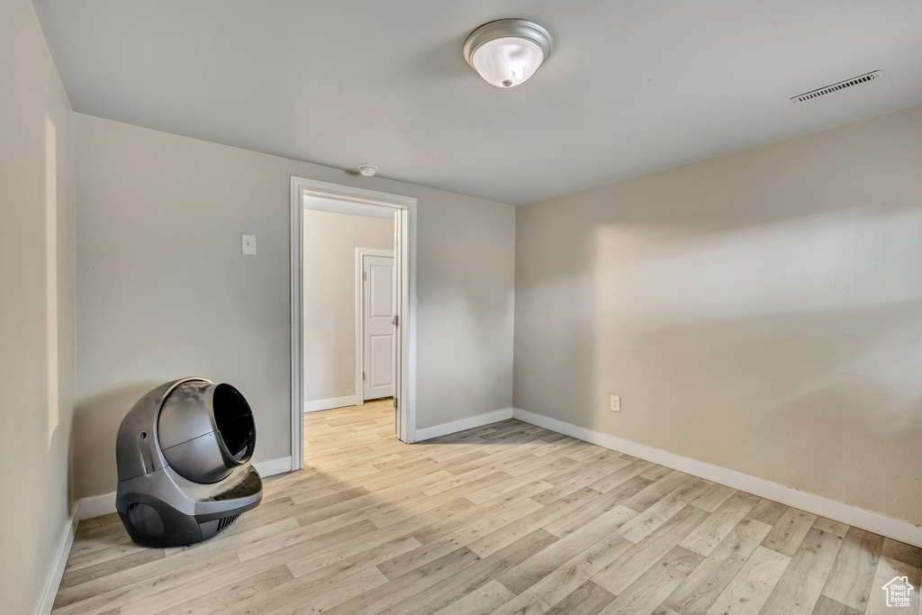 Spare room featuring light wood-style floors and baseboards