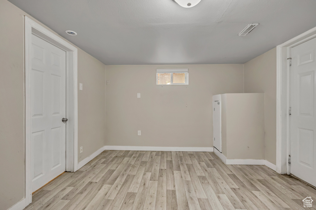 Empty room with light wood-style floors