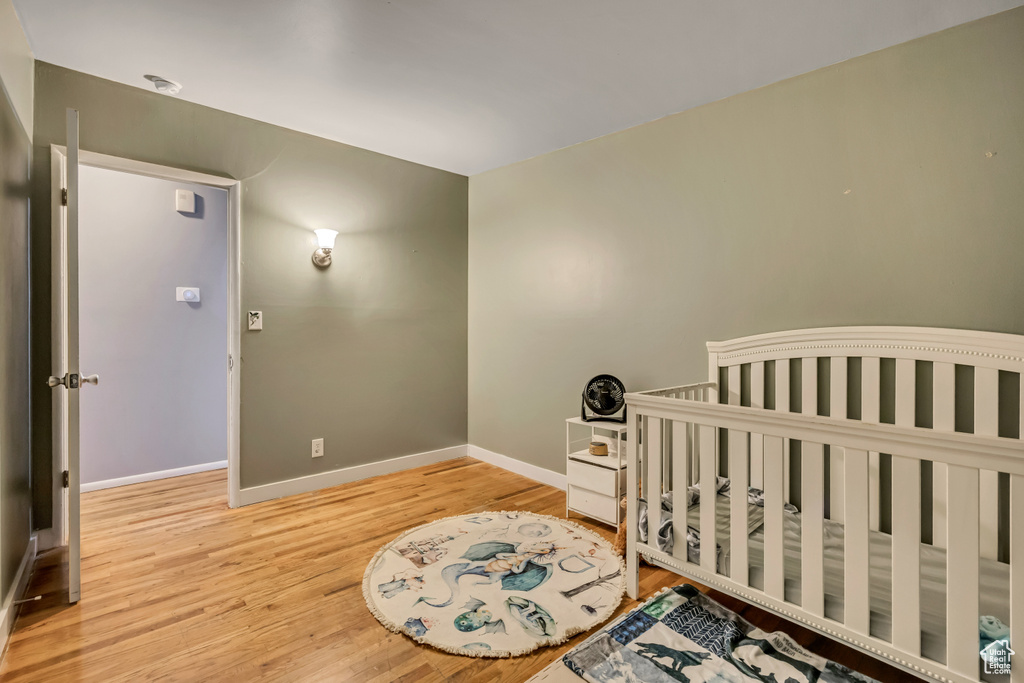 Bedroom featuring wood finished floors and baseboards