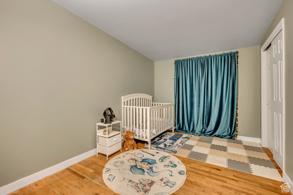 Bedroom featuring wood finished floors and a closet