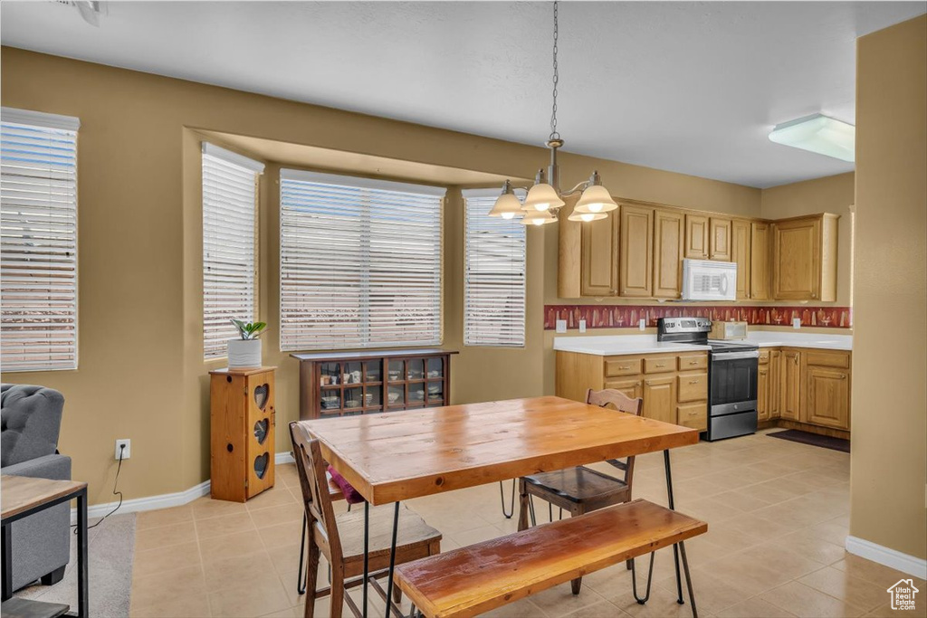 Dining area with a chandelier and light tile patterned floors