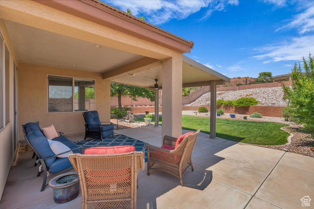 Fenced backyard with a patio area and a ceiling fan