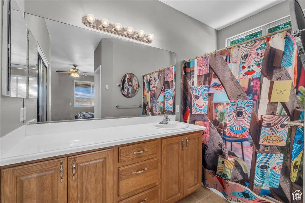 Full bathroom with double vanity, a ceiling fan, tile patterned flooring, and a shower with shower curtain