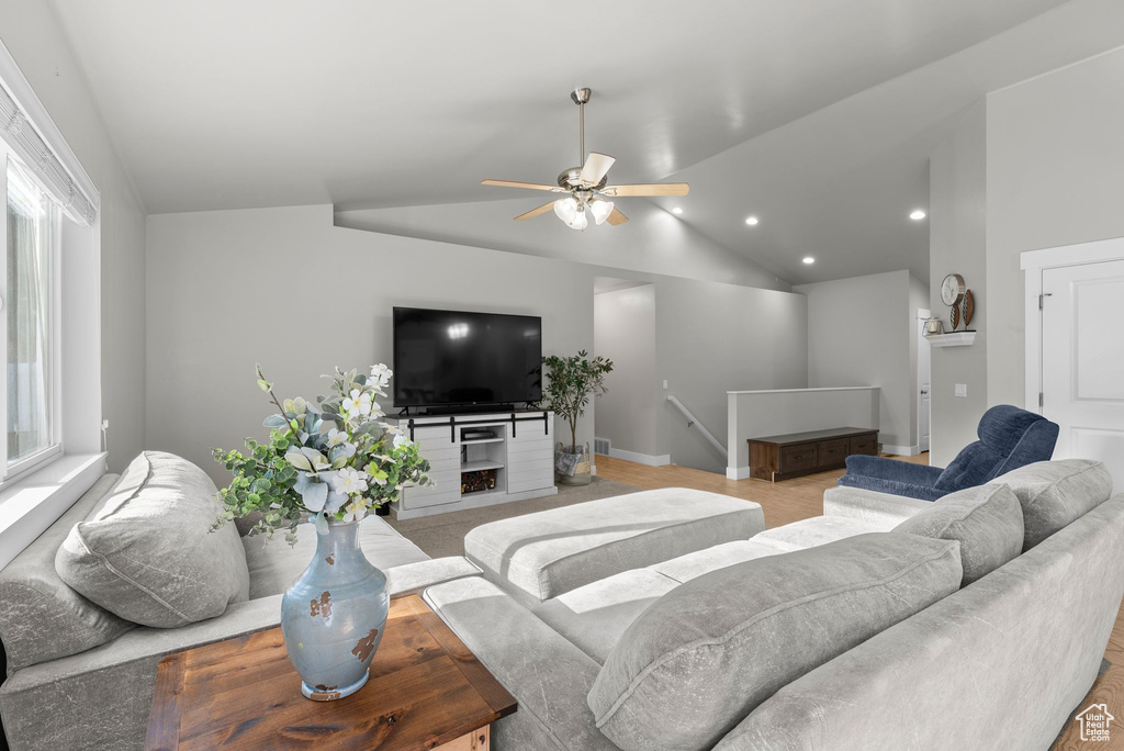 Living room featuring vaulted ceiling, a ceiling fan, and recessed lighting