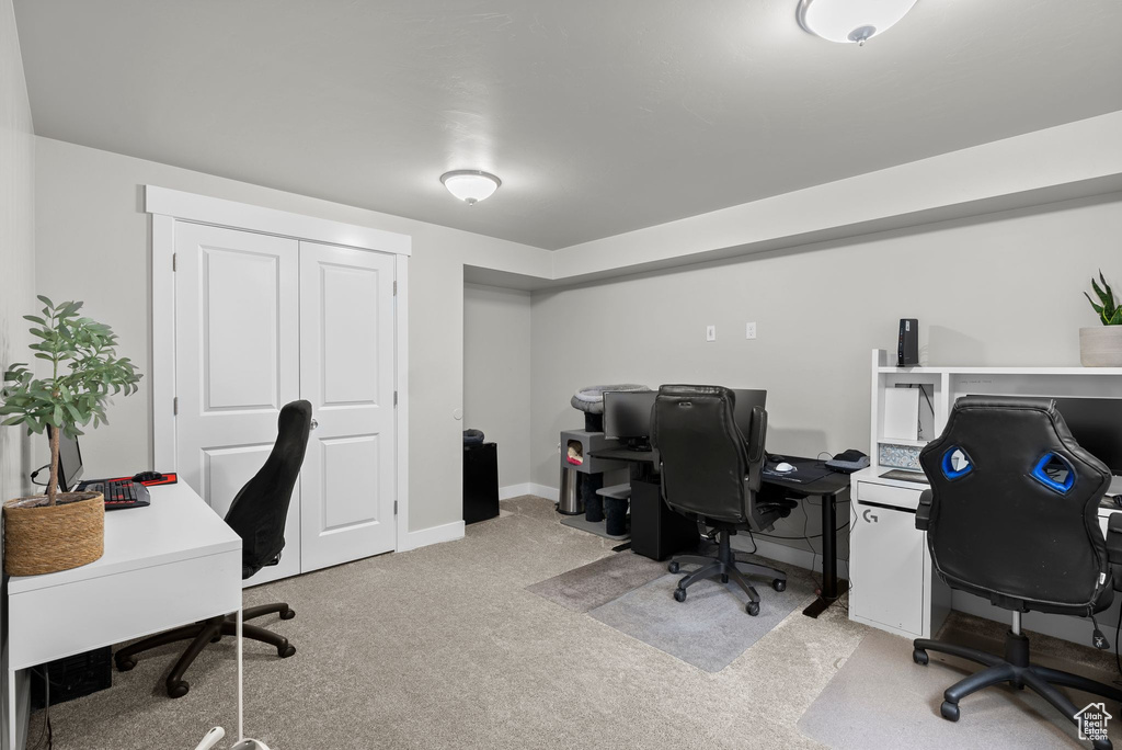 Office area with light colored carpet and baseboards