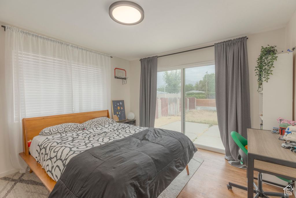 Bedroom featuring access to outside and wood finished floors