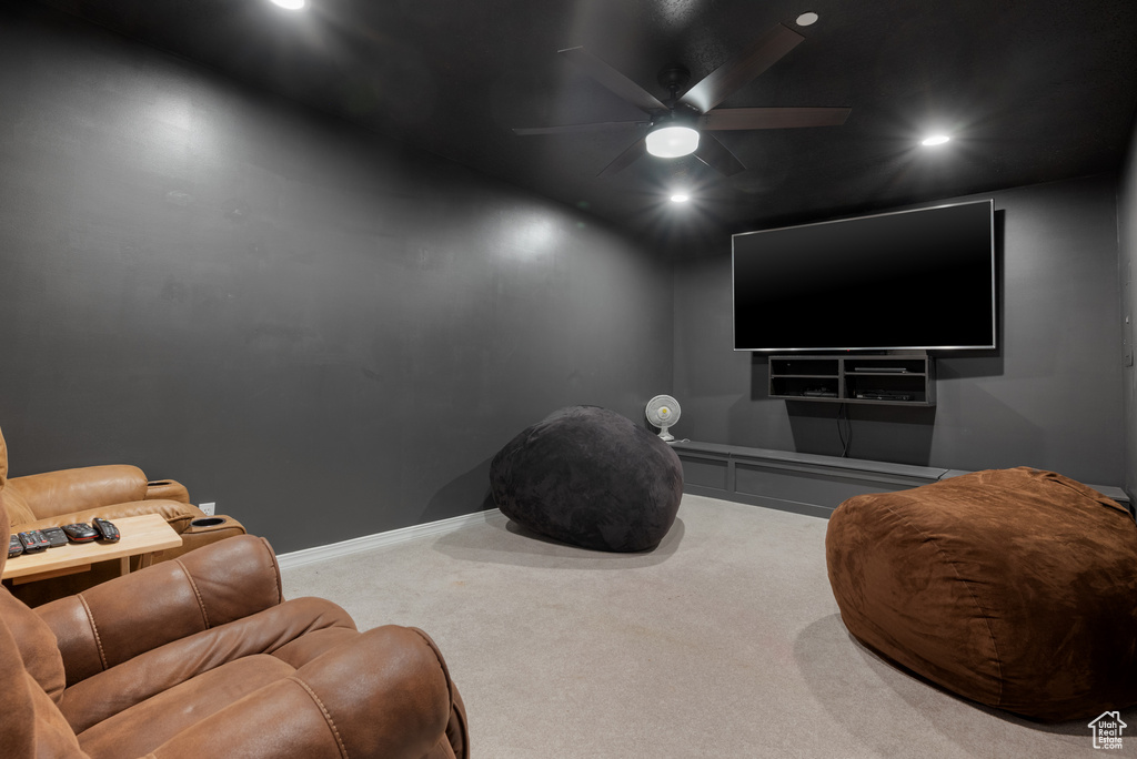 Carpeted home theater with ceiling fan and recessed lighting