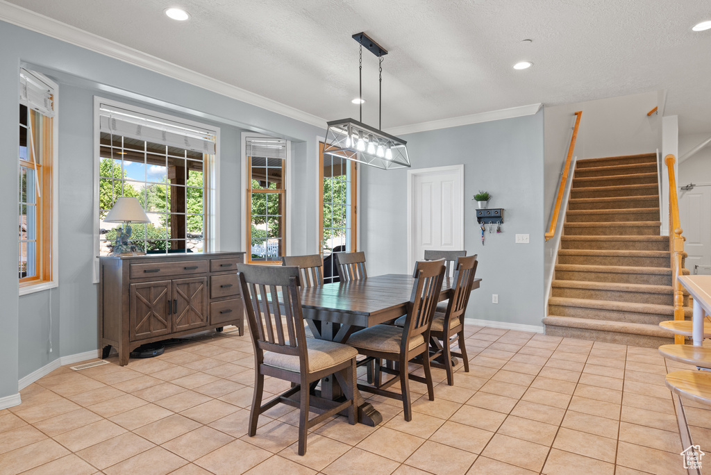 Dining space featuring stairway, light tile patterned floors, crown molding, and recessed lighting