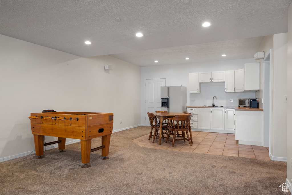 Rec room featuring light colored carpet, recessed lighting, and a textured ceiling