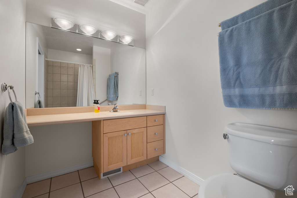 Full bath featuring tile patterned flooring, vanity, and a shower with curtain