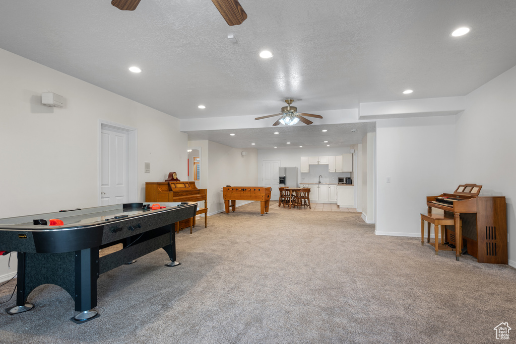 Rec room with a ceiling fan, light carpet, recessed lighting, and a textured ceiling