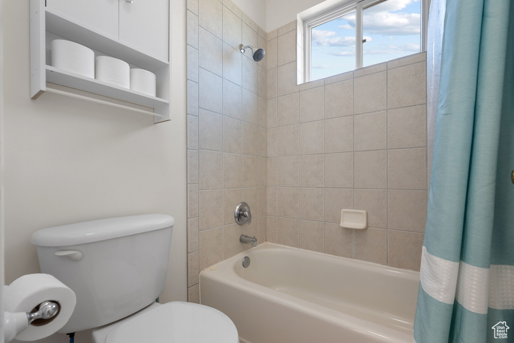 Full bath featuring shower / bath combo and toilet