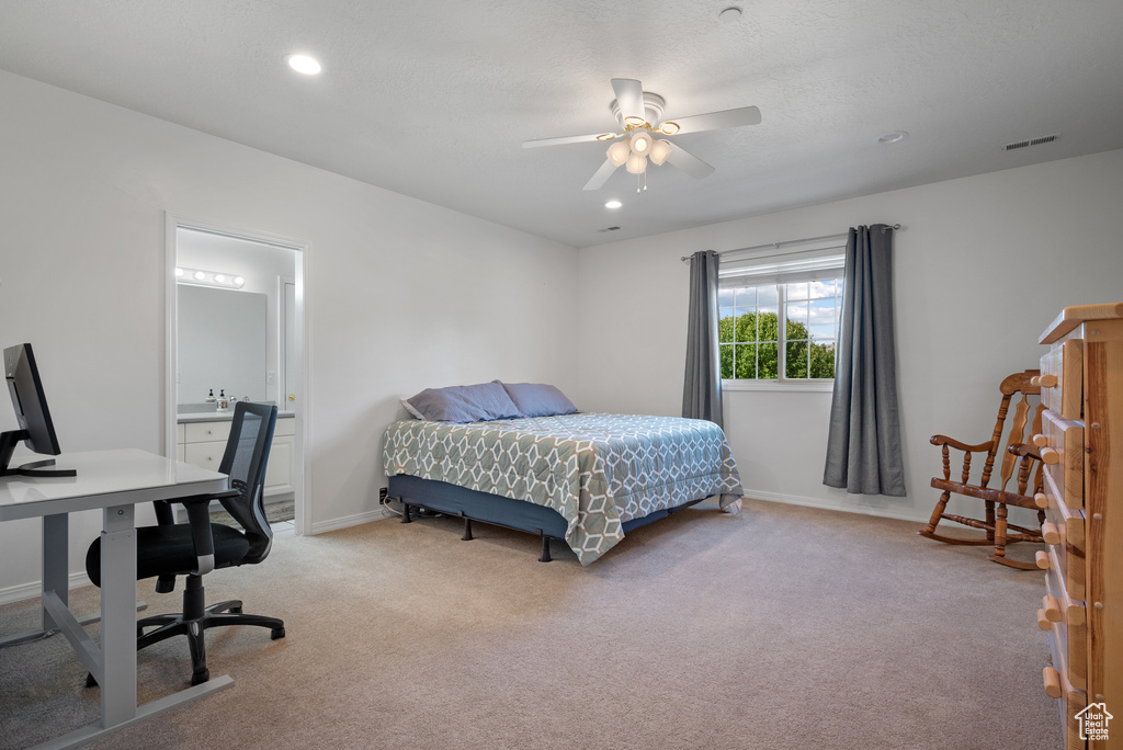 Bedroom with an office area, light colored carpet, recessed lighting, ensuite bathroom, and ceiling fan