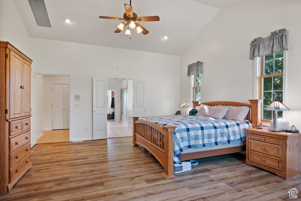 Bedroom with high vaulted ceiling, light wood-style floors, recessed lighting, and ceiling fan