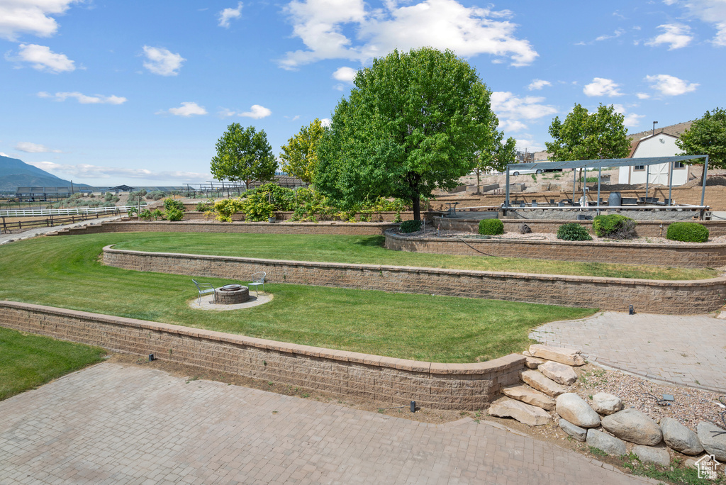 Surrounding community featuring an outdoor fire pit and a mountain view