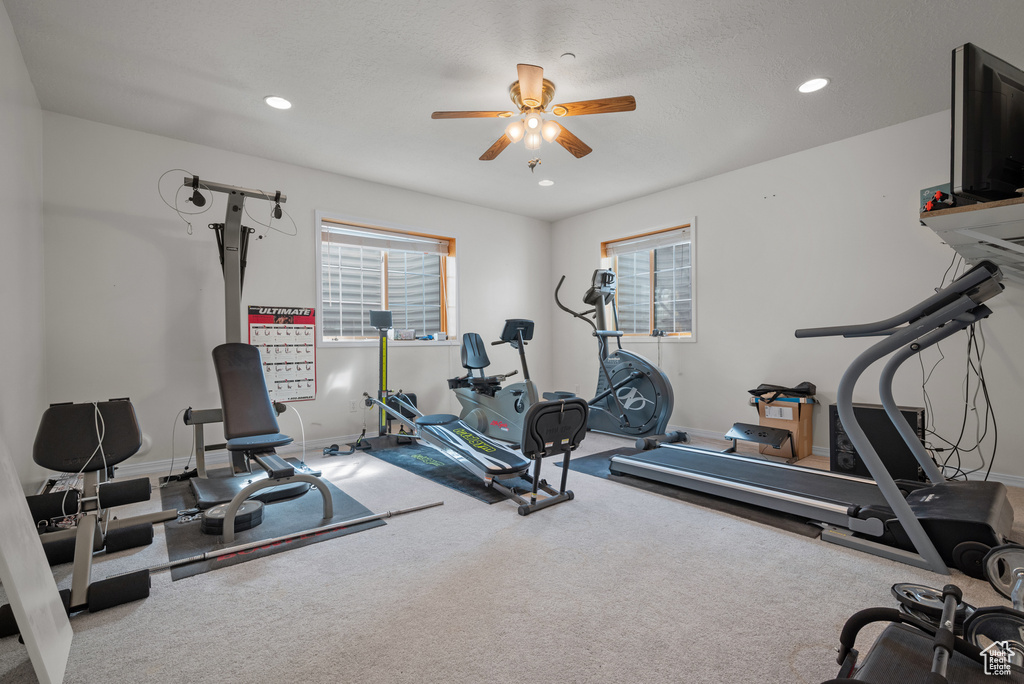 Exercise area featuring a ceiling fan, recessed lighting, and carpet