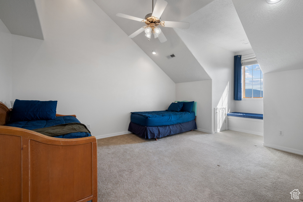 Bedroom featuring lofted ceiling, carpet floors, and ceiling fan
