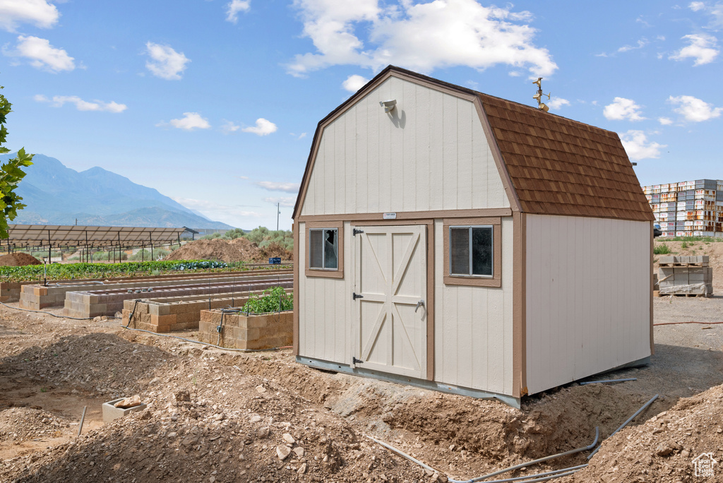 View of shed featuring a garden and a mountain view