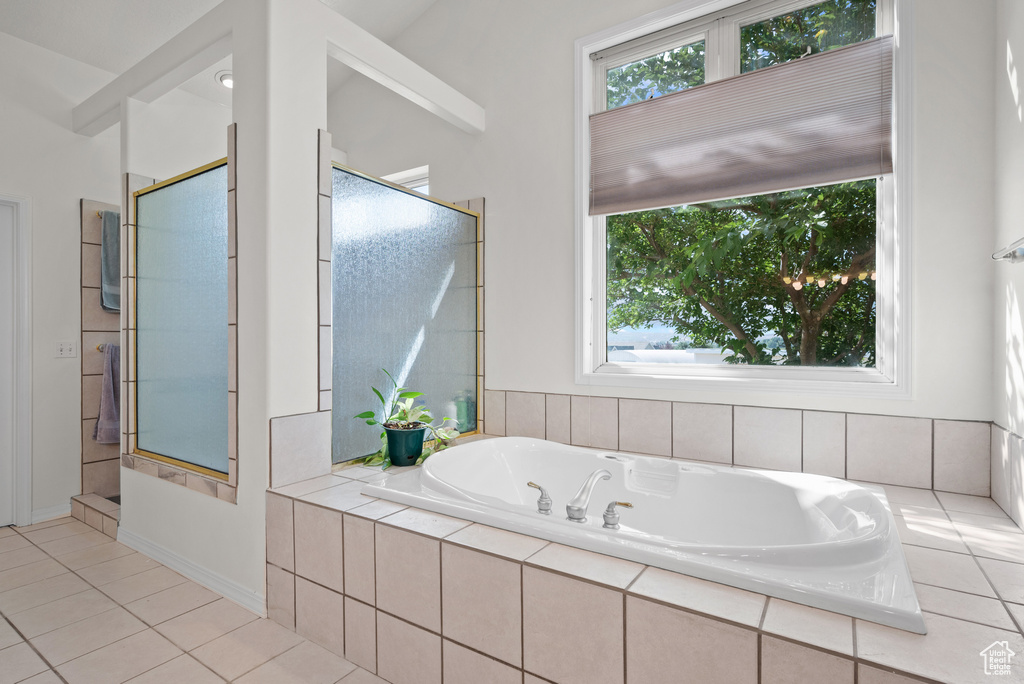 Bathroom with a bath, tile patterned floors, and a shower