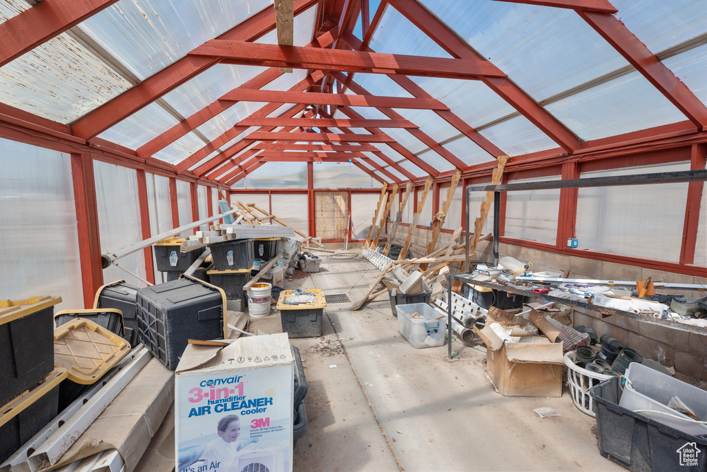 Miscellaneous room with lofted ceiling and concrete floors