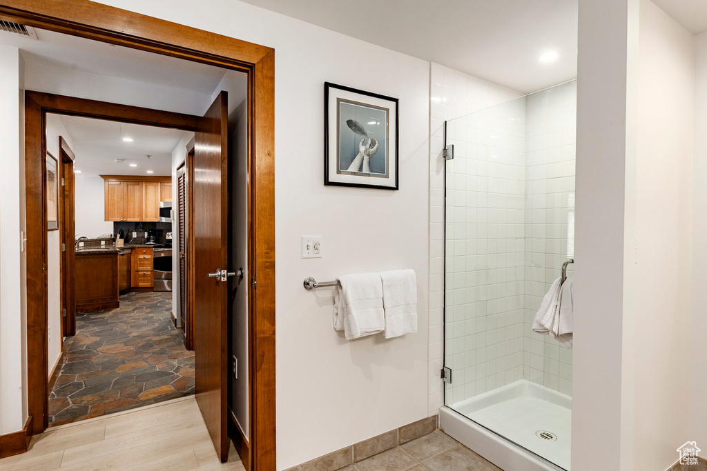 Bathroom featuring a stall shower, recessed lighting, and vanity
