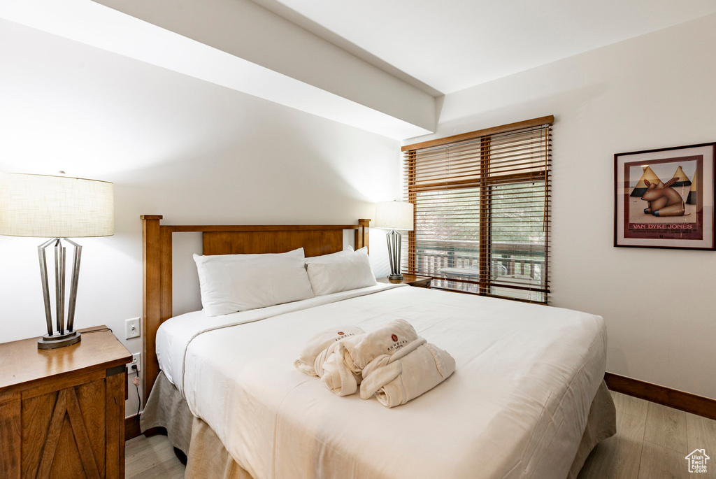 Bedroom featuring wood finished floors and baseboards